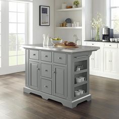 a kitchen island with two open shelves on each side