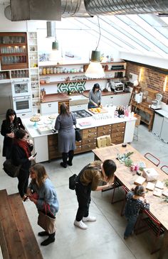 a group of people standing around a kitchen