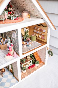 a doll house with christmas decorations on the inside