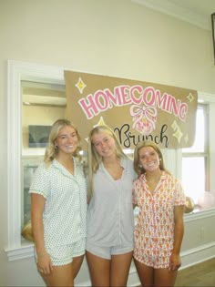 three girls are posing in front of a sign that says, home coming brunch