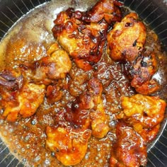 a pan filled with chicken and sauce on top of a stove