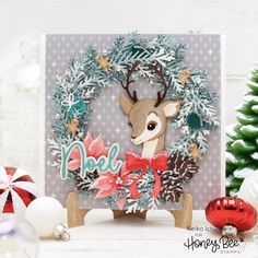 a handmade christmas card with a deer in a wreath and the word noel on it