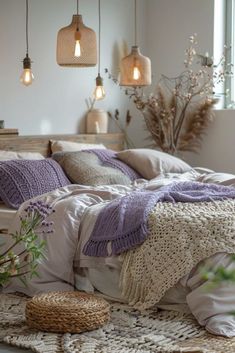 an unmade bed with pillows and blankets in a room filled with flowers, plants and hanging lights