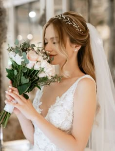 a woman in a wedding dress holding flowers