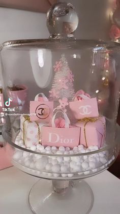 a cake with pink and white decorations on it's glass platter that says dior