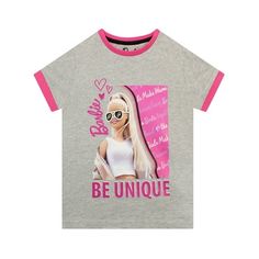 Girls Barbie t-shirt. Let her personality shine with this adorable Barbie tee! Fans of Barbie will love this gray and pink top featuring their favourite fashionista, Barbie! A striking black and white pattern of Barbie's name showcases a print of the iconic doll herself, with the slogan "Be Unique". Your little Barbie girl will love the pink accents on the collar and sleeves matching Barbie's cool pink hairstyle! This stylish Barbie shirt is sure to be a style star in your doll's own wardrobe! 9 Barbie Tees, Barbie Merchandise, Barbie Merch, Fashionista Barbie, Barbie T Shirt, Barbie Shirt, Classic Barbie, Barbie Gifts, Barbie Top