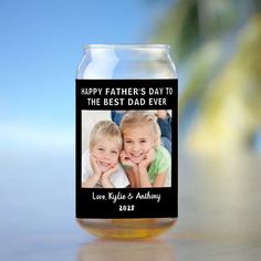 a glass jar with an image of two children on it and the words happy father's day to the best dad ever