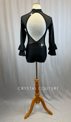 Black long sleeve leotard with double layered ruffle bell sleeves and mesh cutouts. Mock neck and center Lycra panel feature Jet Hematite rhinestones. Costume has 2 gross of rhinestones. **Costume in image is an AM, Photographed on an AS/AM Mannequin with Measurements of: Bust 35", Ribcage 30", Waist 25", Hip 34", Girth 57" Black Leotard Costume, Black Long Sleeve Leotard, Long Sleeve Leotard, Ruffle Bell Sleeve, Rib Cage, Bell Sleeve, Black Long Sleeve, Leotards, Mock Neck