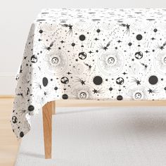 the table cloth has black and white designs on it, with stars in the sky