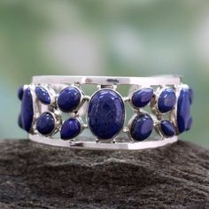 Lapis lazuli in a variety of shapes suggests the summer sea. Set in silver the deep blue gems fill a lacy cuff. This enchanting bracelet comes from Indian designer Neeru Goel. .925 Sterling silver Silver Engraved Bracelet, Floral Cuff, Lapis Jewelry, Lapis Lazuli Jewelry, Women Jewellery, Big Jewelry, Silver Jewelry Necklace, Crystal Jewellery, Silver Jewels