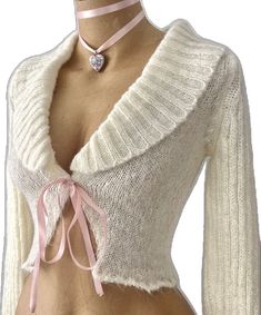 a female mannequin wearing a white sweater with pink ribbon around the neck and chest