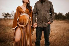 a man standing next to a pregnant woman