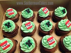 twelve cupcakes with green frosting in a box on top of each other