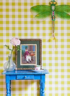 a blue table with a dragon on it next to a yellow and white checkered wall