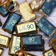 blue and gold birthday crackers with the number 90 on them are surrounded by confetti