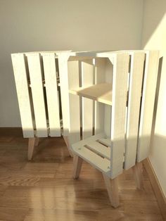 a white cabinet sitting on top of a hard wood floor