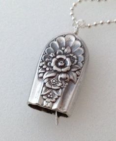 a silver necklace with a flower design on it