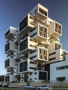 a tall building with multiple balconies on top