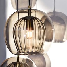 three clear glass lamps hanging from the ceiling