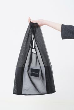 Stylish and practical, our reusable shopping bag is made from 100% polyester organza. It features a square textile Garderob logo. Now available in black, with more colors coming soon. Creative Gift Packaging, Bridesmaids Ideas, Kimono Blouse, Statement Skirt, Gift For Bridesmaids, Textile Bag, Packaging Bag, Wool Wrap, Hooded Raincoat