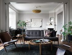 a living room filled with furniture and pictures on the wall