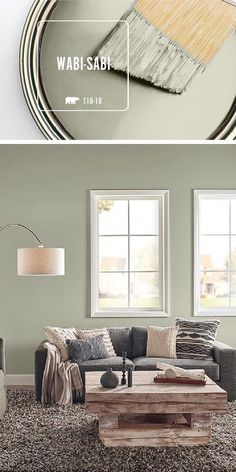 a living room with green walls and white trim on the walls, an image of a gray couch in front of a round mirror