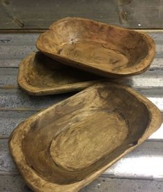 two wooden bowls sitting on top of each other