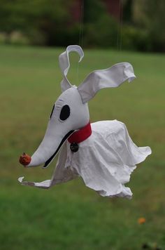 a paper mache dog hanging from a string