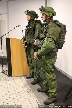 two soldiers standing in front of a podium with microphones on either side of them