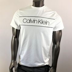 Calvin Klein White Tee With Black Logo. 95% Cotton And 5% Elastane Classic Logo Print T-shirt For Spring, Modern White Top With Logo Print, Modern Logo Tops For Summer, Modern Summer Tops With Logo, Calvin Klein Logo Cotton Tops, Calvin Klein Cotton Logo Tops, Calvin Klein Cotton Tops With Logo, Fitted Cotton Tops With Logo, Logo Fitted Crew Neck Top