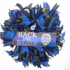 a blue and black wreath with the words back the blue on it