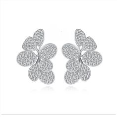 two white gold and diamond earrings with four petals on each side, set in 18k white gold