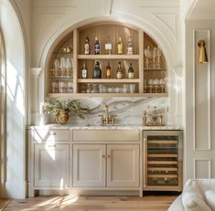 a kitchen filled with lots of counter top space next to a wall mounted wine rack