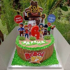 the birthday cake is decorated with cartoon characters