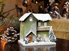 ** Visit our Official Store at timepassagesvillage.com for full inventory availability and discounted pricing. The German Chalet design was inspired by the vintage putz houses.  The house displays moss and trees, is professionally flocked, and placed on a pre-drilled wooden base for use with standard miniature lights or fairy lights.  This house may also be lighted from the back of the house.  This piece is HO scale (1:87:1) which is suitable for the all popular HO trains in case you wish to display them along with the train at Christmas  promoting peace of community! The German Chalet is perfect as a standalone decoration, in a village display, or as the perfect Christmas gift, and can be lighted. As with all of Time Passages houses, this house is handmade, signed, and only a limited quan Vintage Putz Houses, Miniature Lights, Chalet Design, Ho Trains, Village Display, Putz Houses, Ho Scale, Wooden Base, Perfect Christmas Gifts