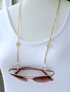 Mediations Gold Eyeglass Sunglasses Chain for Women by Maetri Eyewear. ~~ Beautiful walking meditation swirls adorn this Zen style Gold Glasses Chain and are paired simply with premium gold plated Flat Cable Chain. ~~ Maetri exclusive frosted eyeglass holder ends with Gold slider for sleek style and superior hold on your glasses. ~~ Total length is 26 inches. NEW!! An extra set of Maetri Eyewear custom eyeglass grips are included in the price!! All are eyeglass chains are also updated with end c Eyeglass Holder Necklace, Eyeglass Chains, Walking Meditation, Sunglasses Chain, Gold Glasses, Zen Style, Chain For Women, Eyeglass Chain, Eyeglass Holder