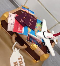 a suitcase with luggage tags attached to it and an airplane tag on the handle next to it