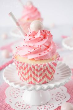 a cupcake with pink frosting on a plate