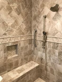 a walk in shower sitting next to a white sink under a faucet mounted on a wall