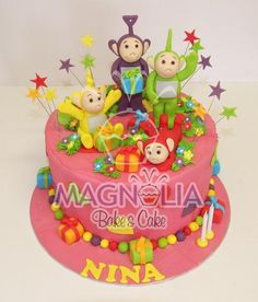 a pink cake decorated with monkeys and stars