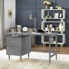 a desk with a laptop on it in front of a bookcase and bookshelf