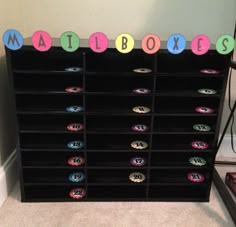 there is a black bookcase with colorful letters on it