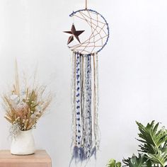 a white wall with a blue and white dream catcher hanging from it's side