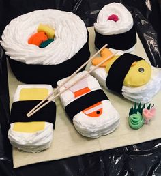 sushi themed cakes are sitting on a table with chopsticks in the middle