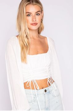 Romance will follow in the Je T'aime White Bubble Sleeve Crop Top! Lightweight fabric forms a ruched white fabric forms a crop top bodice, framed by long bubble sleeves, and drawstring ties at hem. White Long Sleeve Crop Top, White Lace Crop Top, Ruched Crop Top, Boho Pink, Boho Boutique, Bubble Sleeve, Pink Boho, High Waisted Jeans, Lace Crop Tops