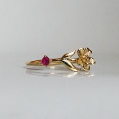 Our special collection of birth flower rings are inspired by the love of wearing something meaningful. Each birth flower is adorned with that month's birthstone. July's birth flower is Water Lily and the birthstone is ruby. Materials: 14K solid gold 2mm natural ruby 1.1mm band thickness ** This item is specially made for you. Please allow 1-2 week lead time. Shipping:Domestic: Free standard shipping within the U.S.International: Free standard shipping for orders over $200 Customization:- Interes Flower Of Month, July Water Lily, July Birth Flower, Ring With Ruby, Flower Rings, Mother Rings, Birth Flower, Water Lily, Birth Flowers