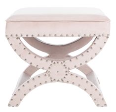 a white bench with studded legs and a cushion on the top, sitting against a white background