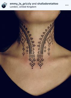 a woman's neck with an intricate design on the top and bottom part of her neck