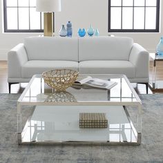 a modern living room with white furniture and blue vases