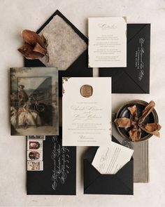 an assortment of black and white wedding stationery